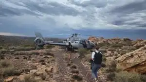 helicopter and men in mountains
