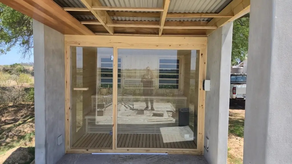 Glass front outdoor sauna installation Johannesburg.